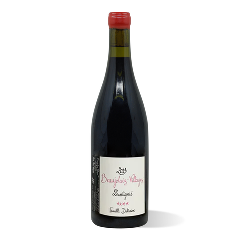 A dark green wine bottle with red wax seal and white label bearing curly pink and black script.